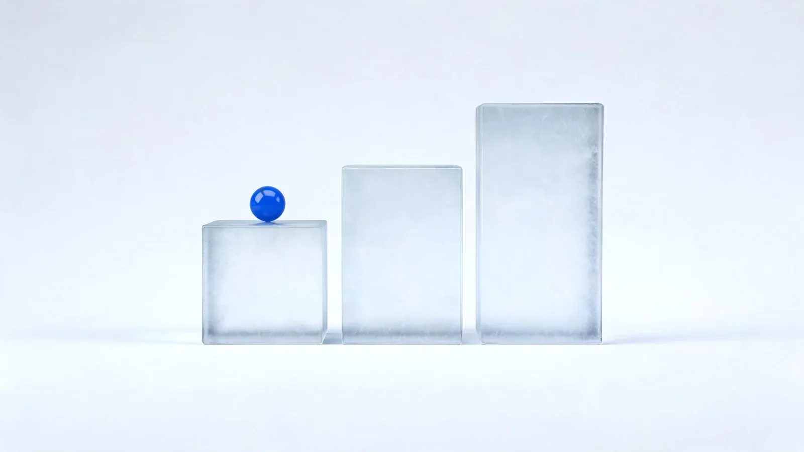 Three frosted-glass blocks rising in height like steps, with a small blue sphere on the lowest one, on a light grey background.